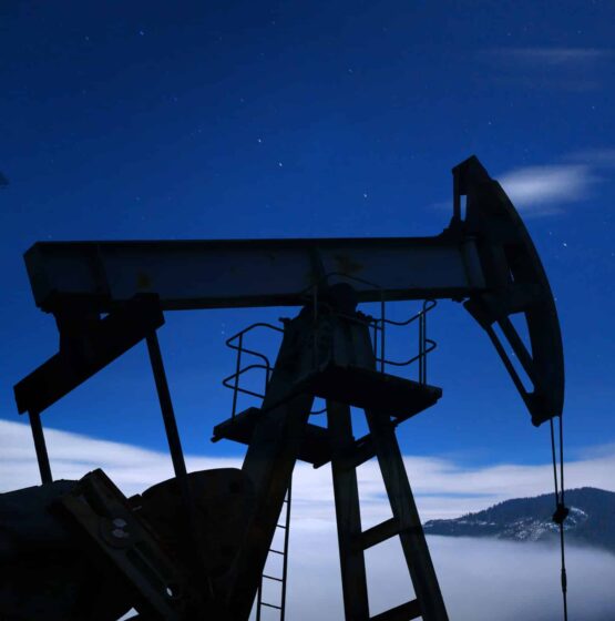 Oil pump silhouette at night.